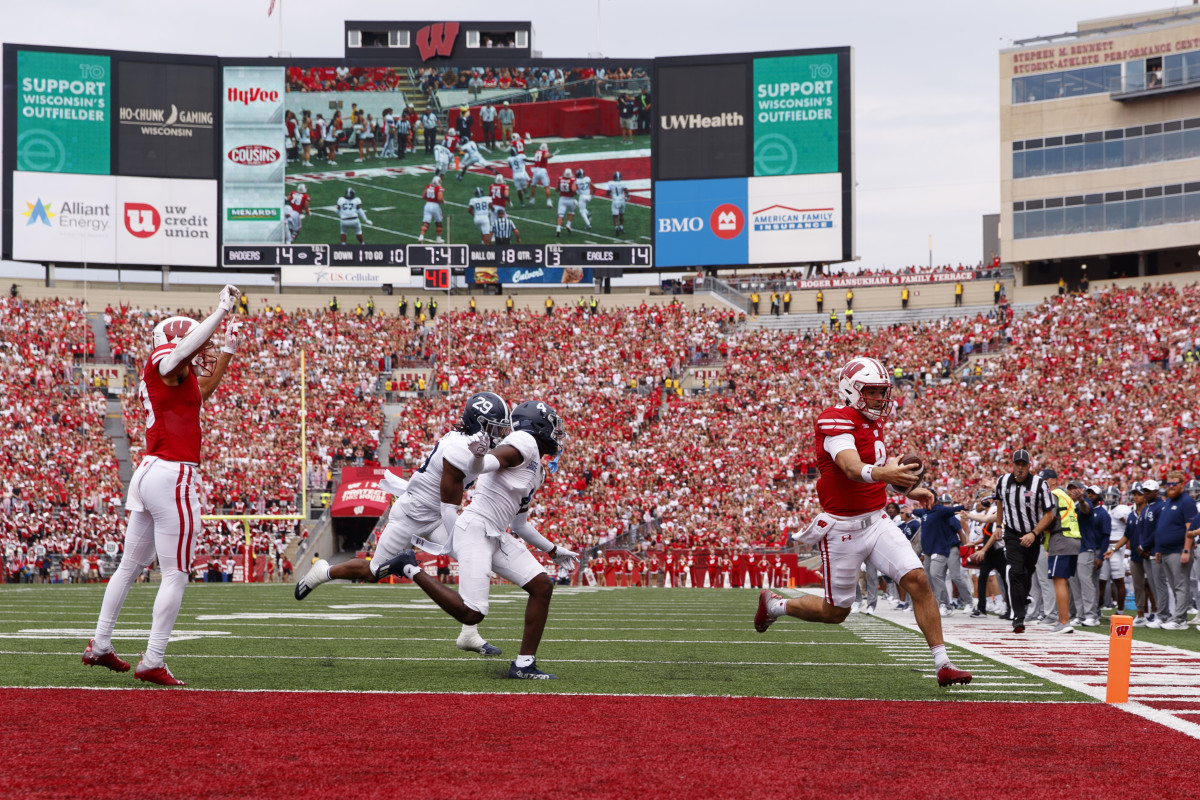 Sep 16, 2023; Madison, Wisconsin, USA; Wisconsin Badgers quarterback Tanner Mordecai (8) rushes for a touchdown during the third quarter against the Georgia Southern Eagles at Camp Randall Stadium. Mandatory Credit: Jeff Hanisch-USA TODAY Sports