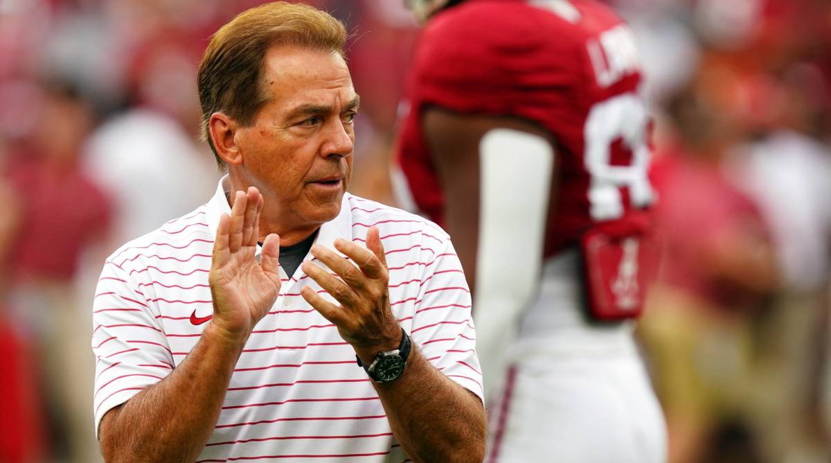 Alabama head coach Nick Saban claps on the field before a game.