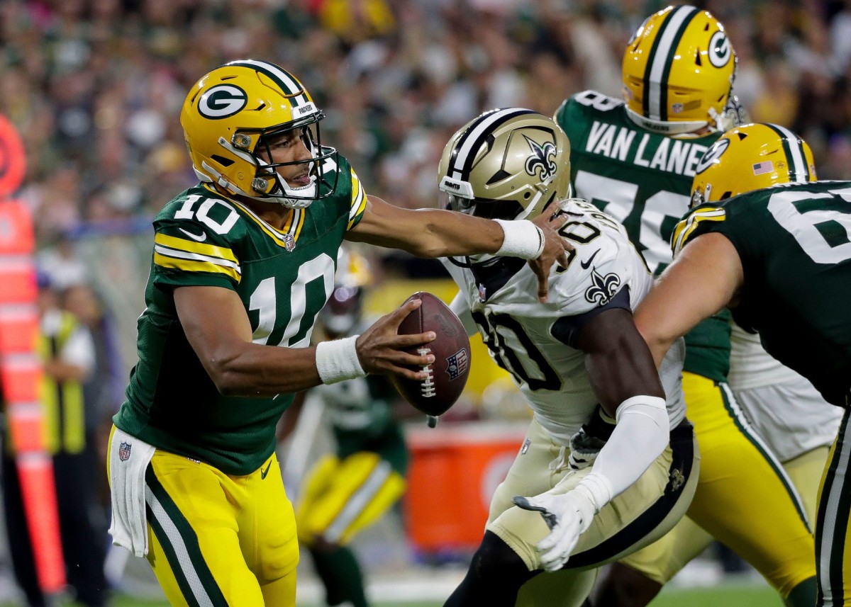 August 19, 2022; Green Bay Packers quarterback Jordan Love (10) scrambles in the pocket as New Orleans Saints defensive end Tanoh Kpassagnon (90) closes in. © Tork Mason / USA TODAY NETWORK