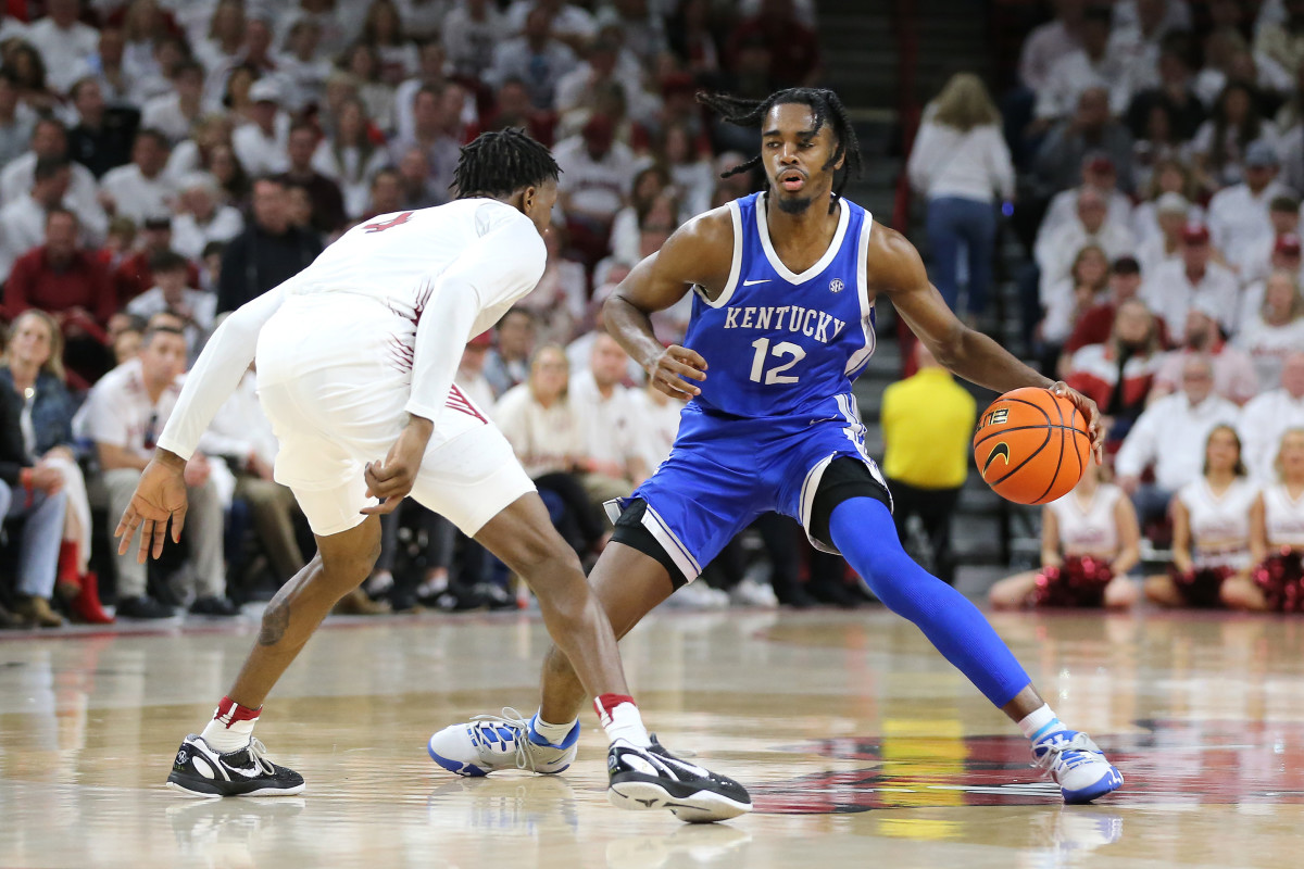 Mar 4, 2023; Fayetteville, Arkansas, USA; Kentucky Wildcats guard Antonio Reeves 912) drives against Arkansas Razorbacks guard Davonte Davis (4) during the first half at Bud Walton Arena. Kentucky won 88-79. Mandatory Credit: Nelson Chenault-USA TODAY Sports