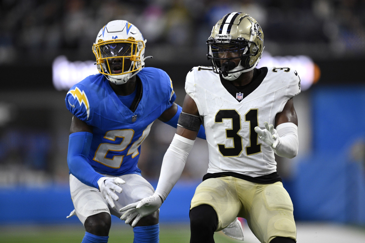 Los Angeles Chargers safety AJ Finley (24) and New Orleans Saints safety Jordan Howden (31) battle during a punt return