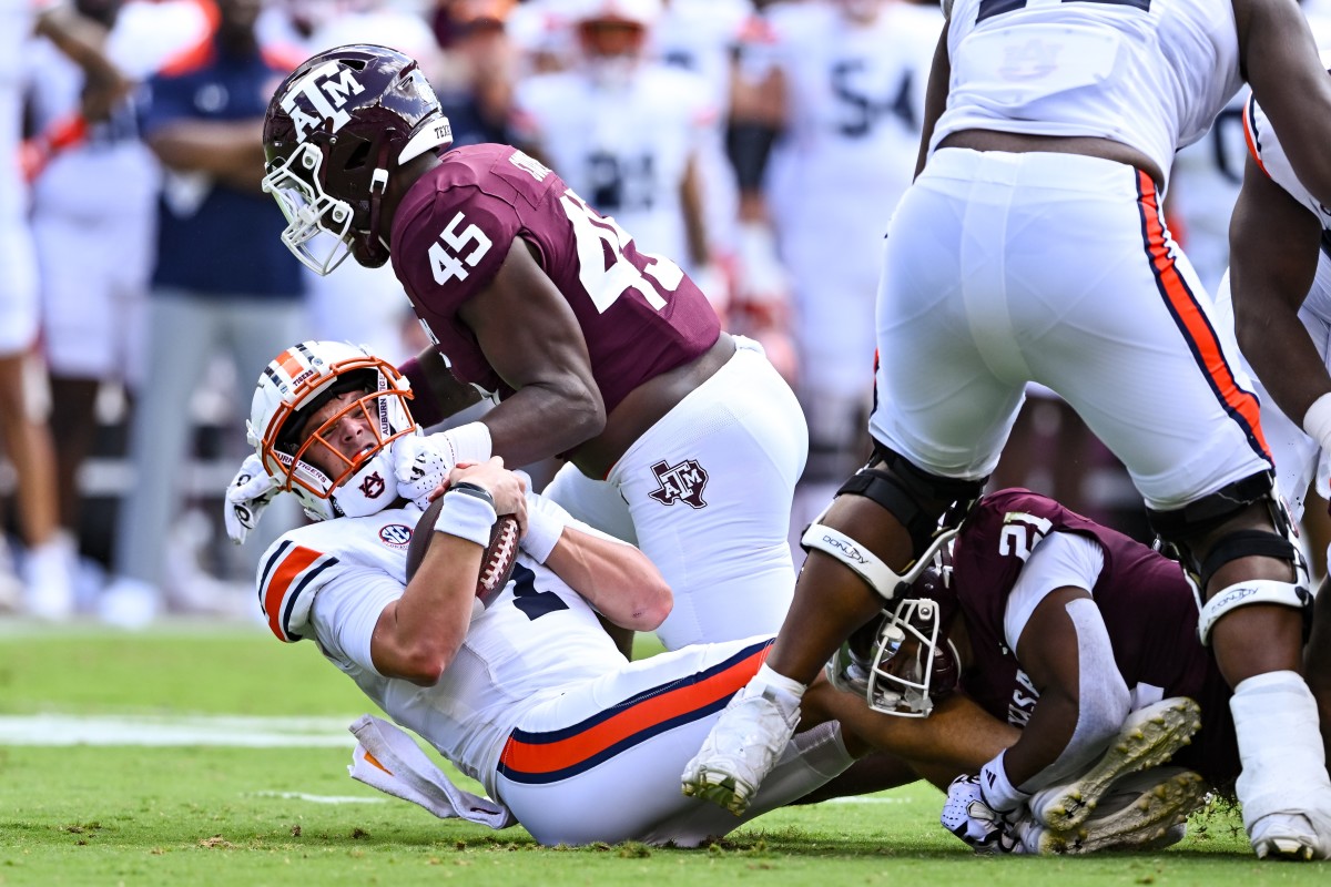 Sep 23, 2023; College Station, Texas, USA; Texas A&M Aggies linebacker Edgerrin Cooper (45) sacks Auburn Tigers quarterback Payton Thorne (1) during the first half at Kyle Field. Mandatory Credit: Maria Lysaker-USA TODAY Sports  