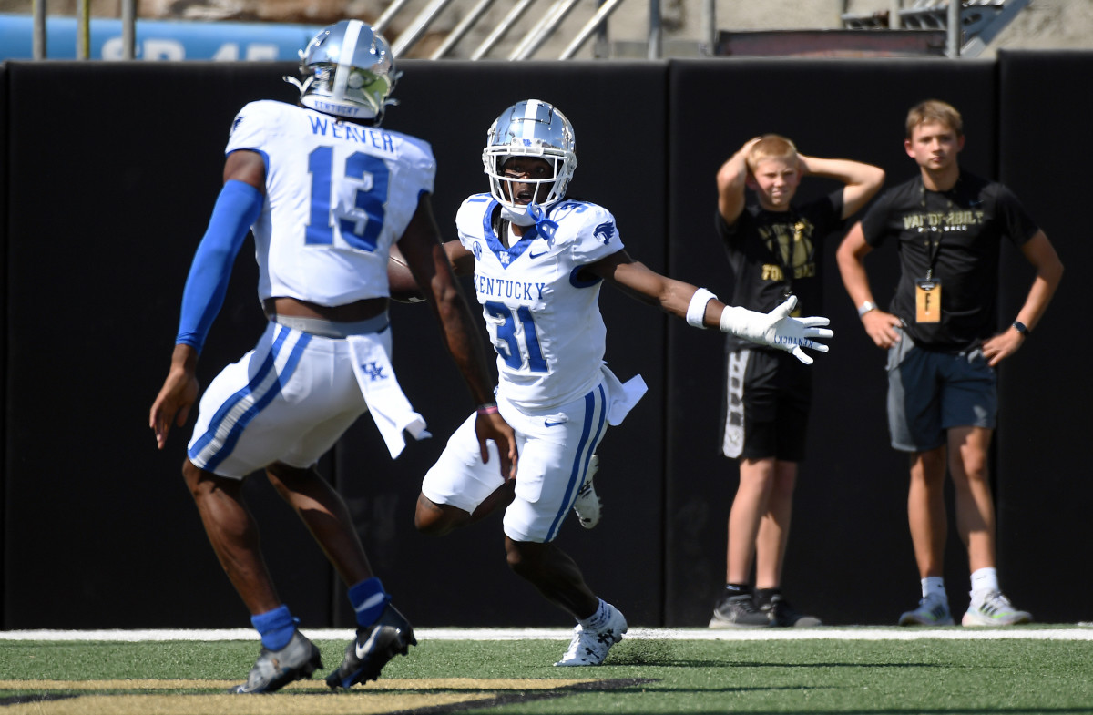 Sep 23, 2023; Nashville, Tennessee, USA; Kentucky Wildcats defensive back Maxwell Hairston (31) celebrates after returning an interception for a touchdown against the Vanderbilt Commodores during the first half at FirstBank Stadium. Mandatory Credit: Christopher Hanewinckel-USA TODAY Sports