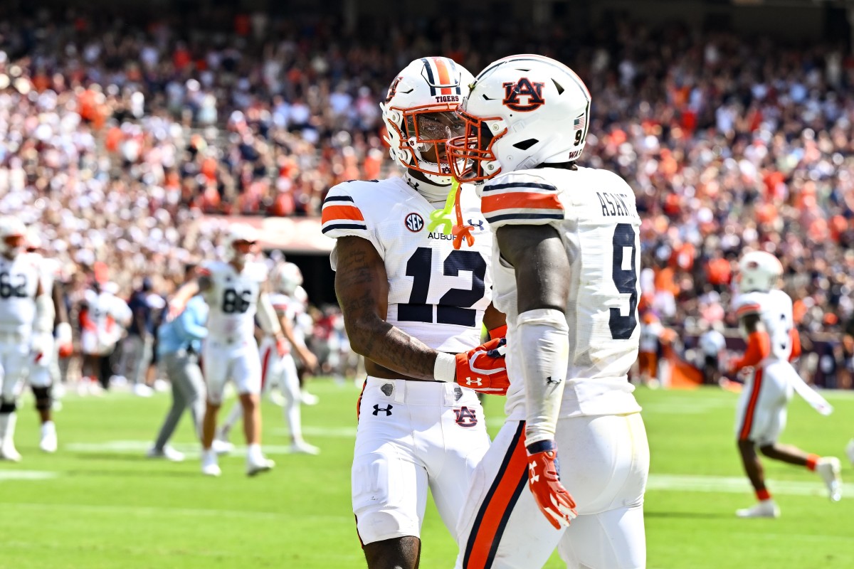 Sep 23, 2023; College Station, Texas, USA; Auburn Tigers quarterback Holden Geriner (12) congratulates linebacker Eugene Asante (9) on his touchdown in the fourth quarter against the Texas A&M Aggies at Kyle Field. Mandatory Credit: Maria Lysaker-USA TODAY Sports  