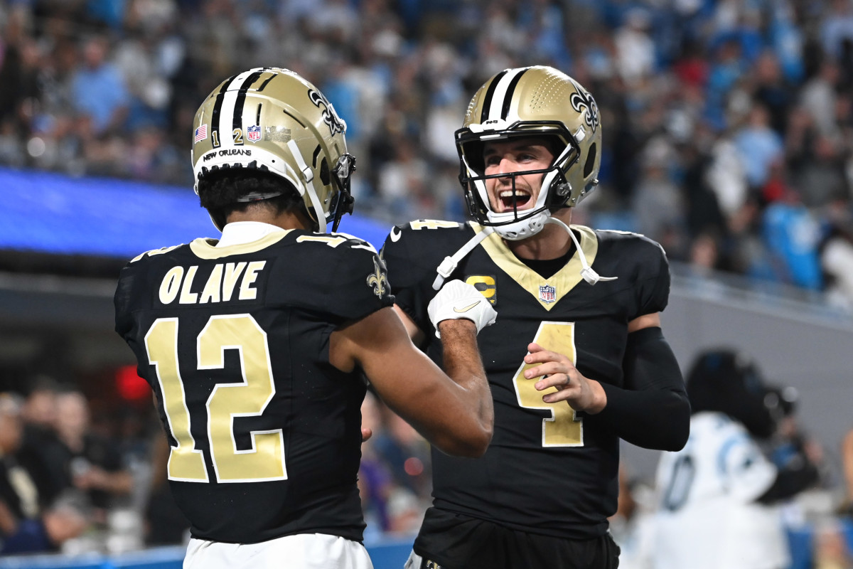 New Orleans Saints quarterback Derek Carr (4) reacts with wide receiver Chris Olave (12) in the fourth quarter