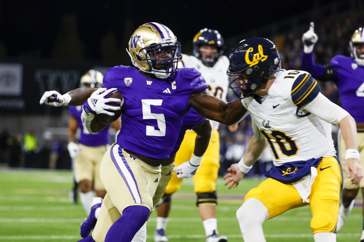 Edefuan Ulofoshio pushes his way past Cal quarterback Ben Finley on the way toa 45-yard interception return for a score.