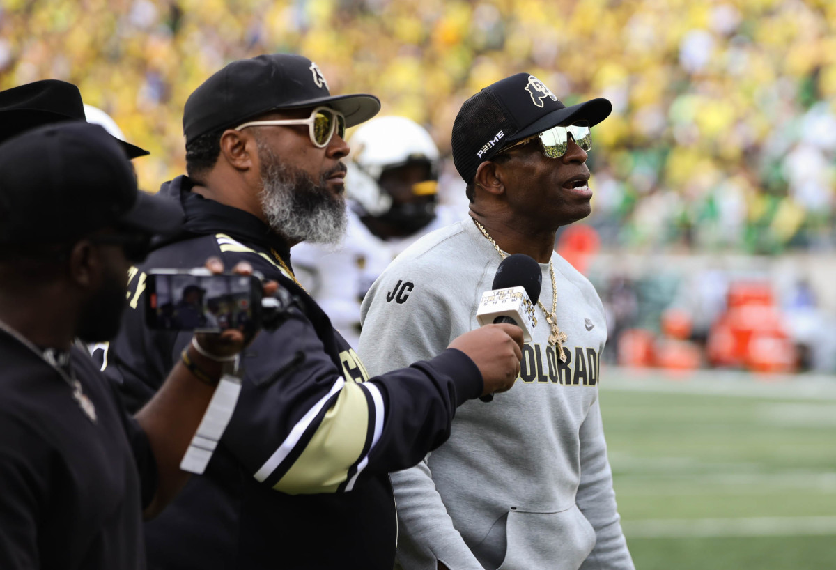 Coach Prime walking off the field at Oregon