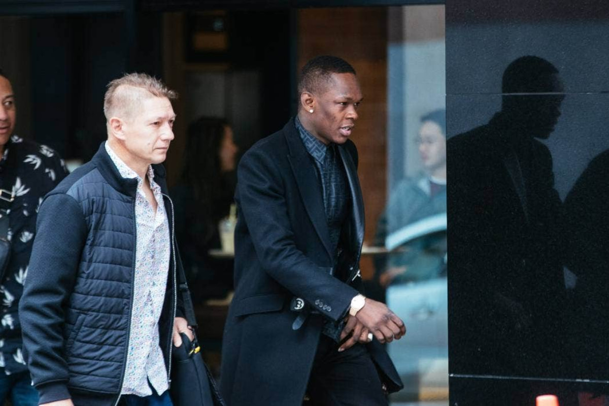 Israel Adesanya steps outside following a court appearance in New Zealand.