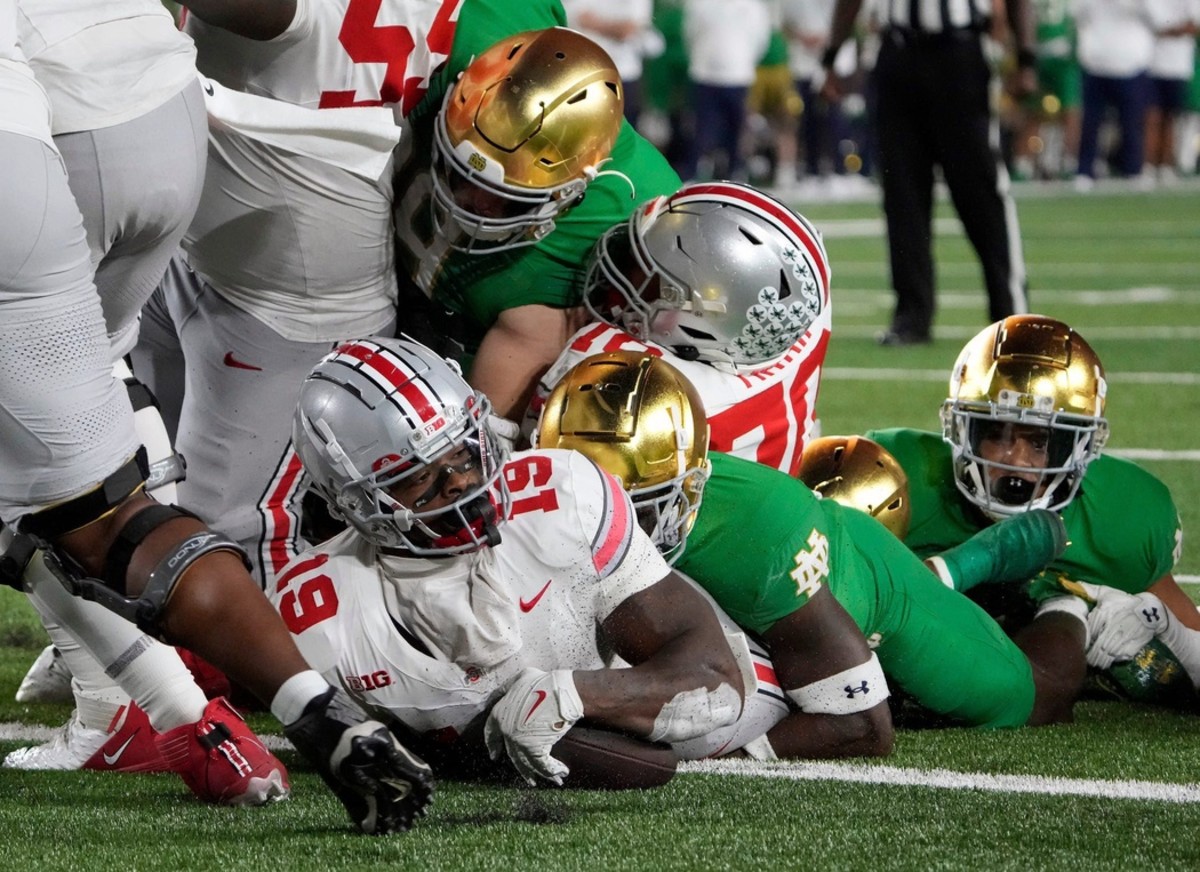 Ohio State Buckeyes running back Chip Trayanum (19) scores the game-winning rushing touchdown against Notre Dame Fighting Irish during the fourth quarter of their game at Notre Dame Stadium.