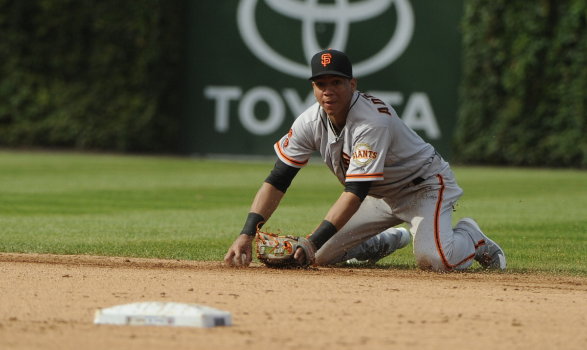 SF Giants shortstop Ehire Adrianza (1) makes a play against the Chicago Cubs in the eighth inning of their game at Wrigley Field. (2016)