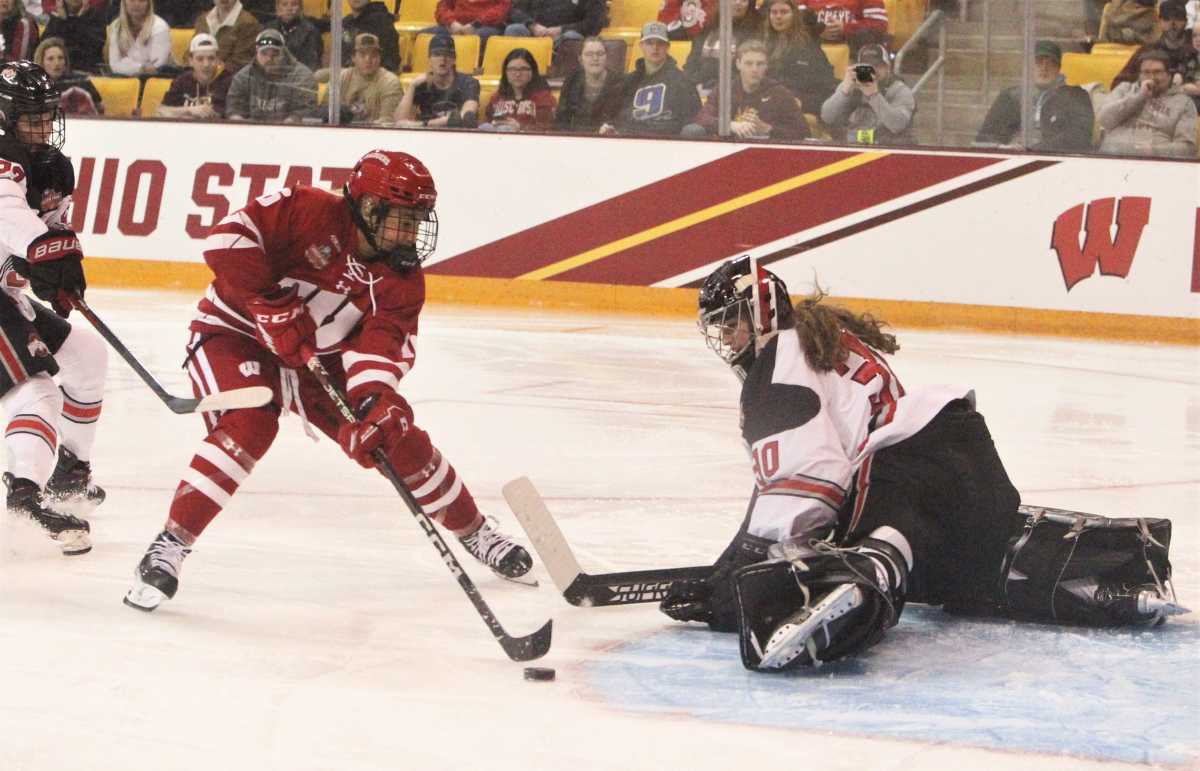 Wisconsin's Claire Enright (16) tries to shoot the puck past Ohio State's Amanda Thiele during the NCAA Division I women's hockey final on Sunday March 19, 2023 at AMSOIL Arena in Duluth, Minn. Uwice Ohio State 11 March 19 2023