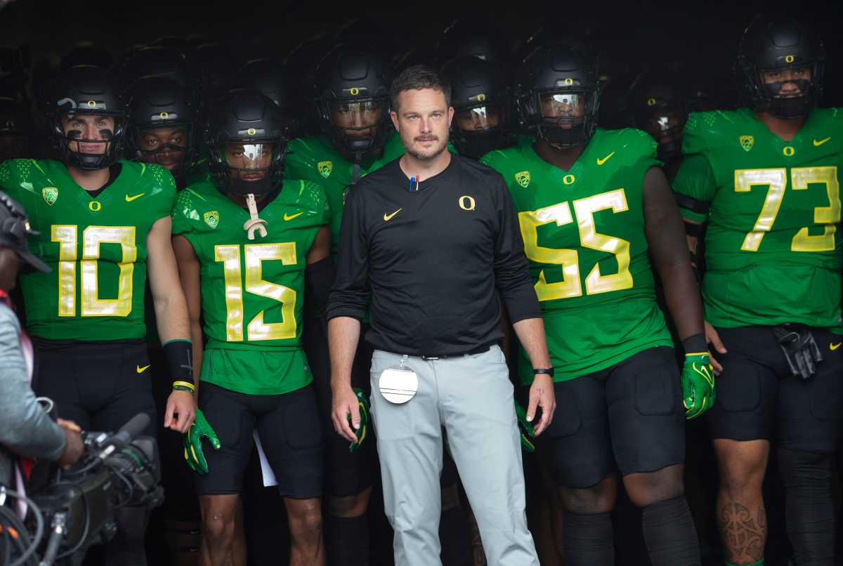 Oregon coach Dan Lanning leads his team onto the field before the game against Colorado in Eugene Saturday, Sept. 23, 2023.