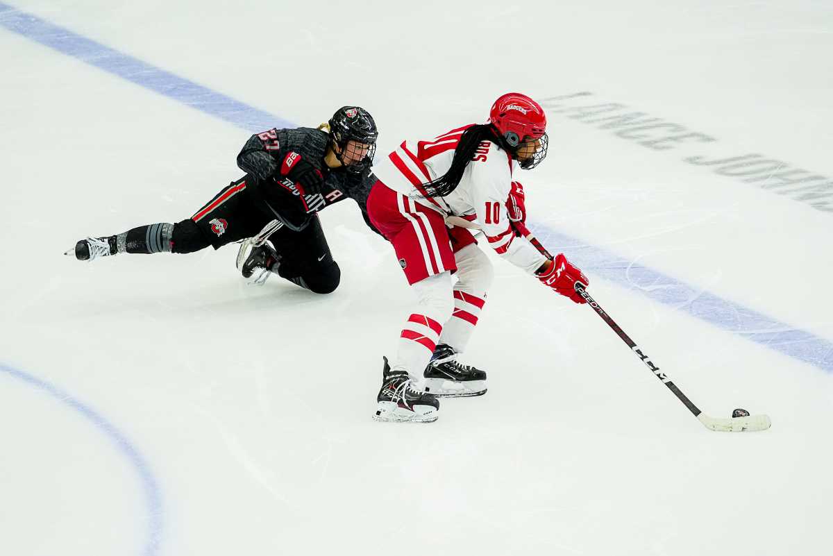 Ohio State forward Paetyn Levis (27) dives in an attempt to poke the puck away from Wisconsin forward Laila Edwards (10) during the second period Saturday February 18, 2023 at LaBahn Arena in Madison, Wis.