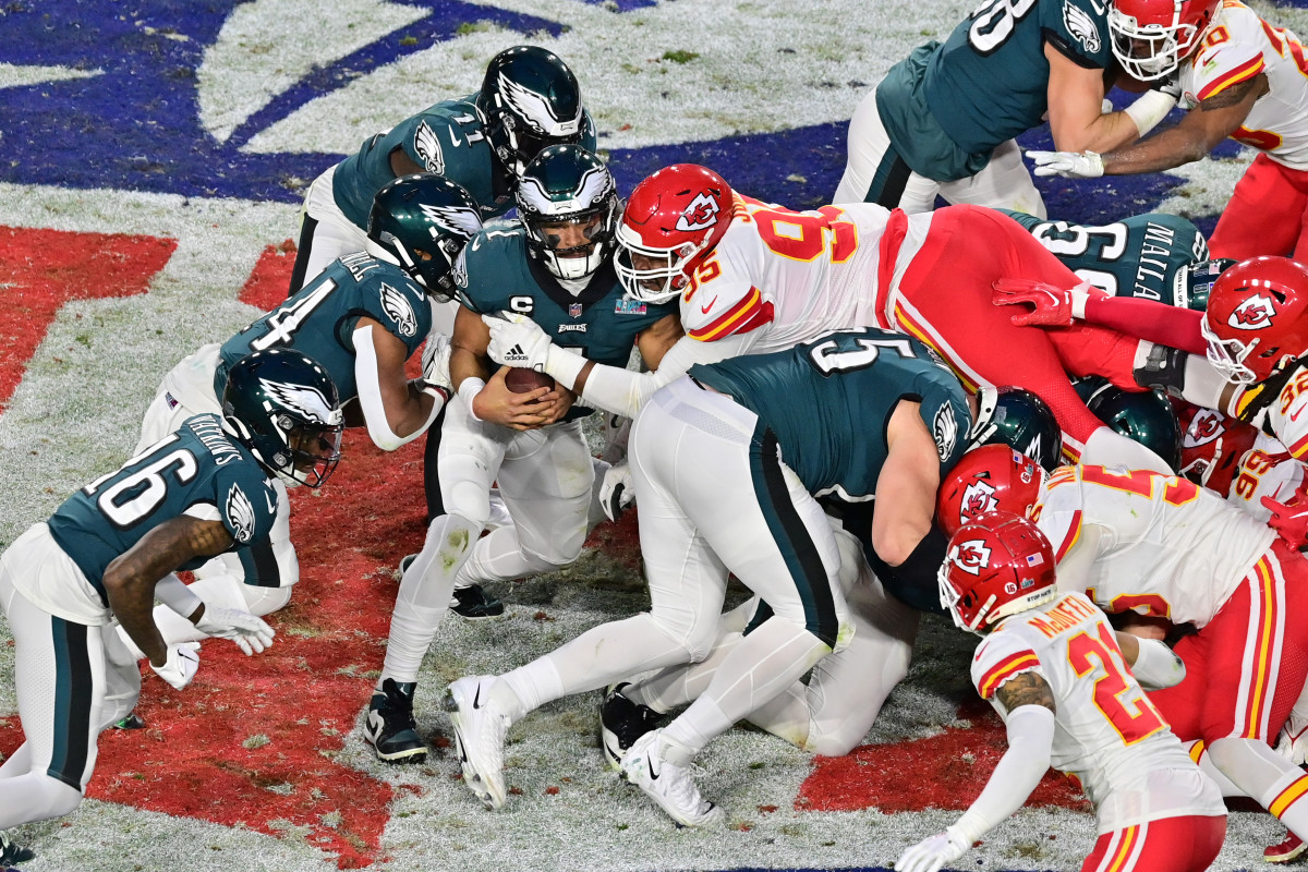 Kansas City Chiefs defensive tackle Chris Jones (95) tackles Philadelphia Eagles quarterback Jalen Hurts (1) on a quarterback sneak during the second quarter of Super Bowl LVII at State Farm Stadium.