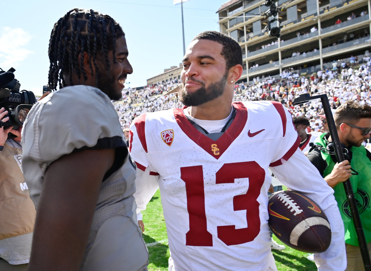 Colorado Buffaloes quarterback Shedeur Sanders (2) meets with USC Trojans quarterback Caleb Williams (13) after the game at Folsom Field