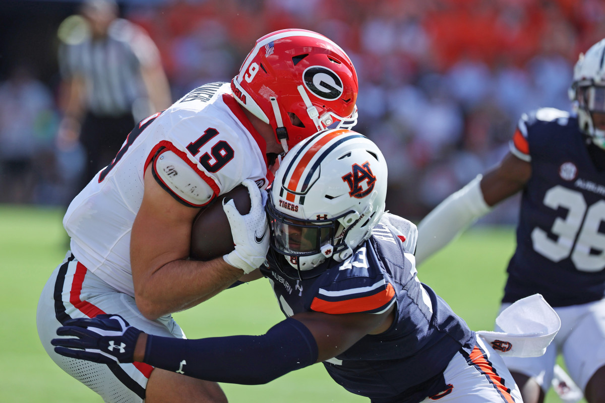 Sep 30, 2023; Auburn, Alabama, USA; Auburn Tigers linebacker Cam Riley (13) tackles Georgia Bulldogs tight end Brock Bowers (19) during the first quarter at Jordan-Hare Stadium. Mandatory Credit: John Reed-USA TODAY Sports