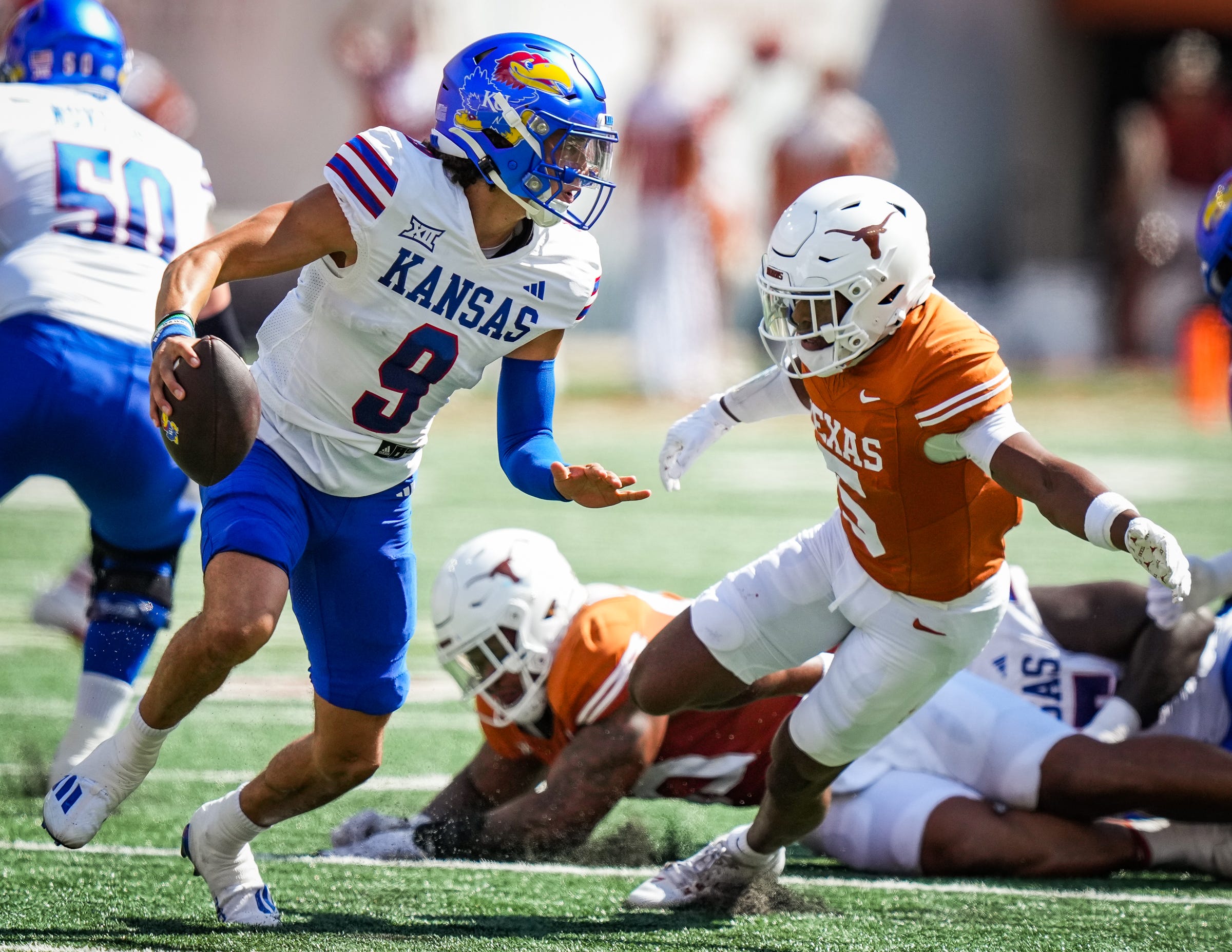 Texas Longhorn defensive back Malik Muhammad puts quarterback pressure on Jason Bean.