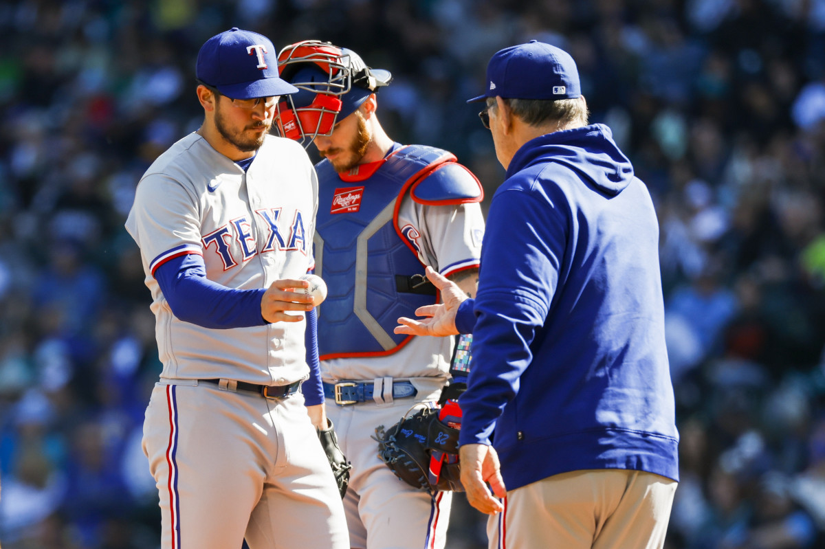 Oct 1, 2023; Seattle, Washington, USA; Texas Rangers starting pitcher Dane Dunning (33) hands the ball over to Texas Rangers manager Bruce Bochy (15) during a fourth inning pitching change against the Seattle Mariners at T-Mobile Park. Mandatory Credit: Joe Nicholson-USA TODAY Sports