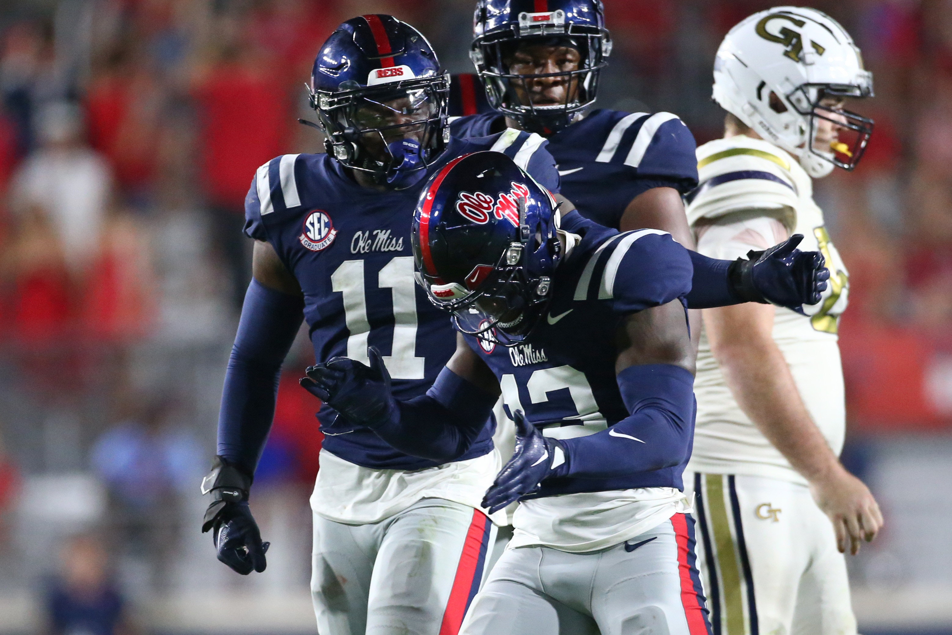 Sep 16, 2023; Oxford, Mississippi, USA; Mississippi Rebels linebacker Jeremiah Jean-Baptiste (11) reacts with Mississippi Rebels defensive back Ladarius Tennison (13) after a tackle during the second half against the Georgia Tech Yellow Jackets at Vaught-Hemingway Stadium. Mandatory Credit: Petre Thomas-USA TODAY Sports