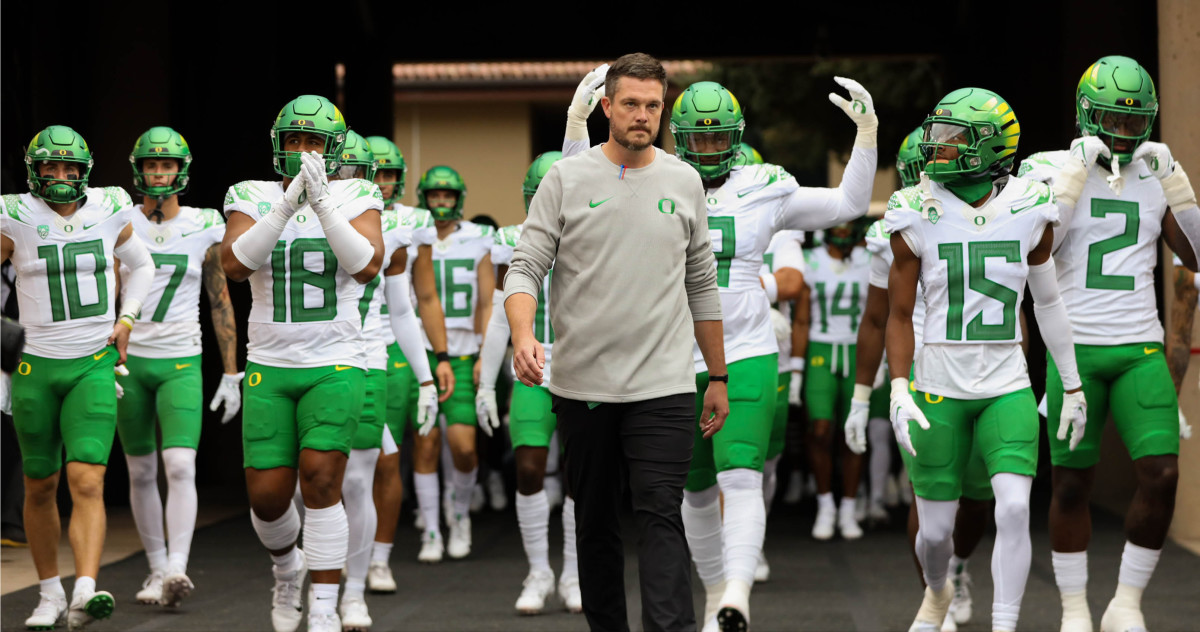 Oregon Ducks head coach Dan Lanning and players walk out of the tunnel before facing the Stanford Cardinal.