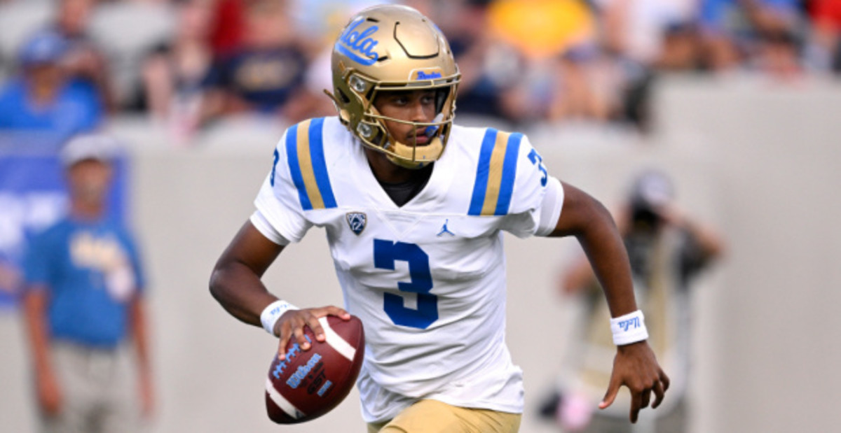 UCLA Bruins quarterback Dante Moore rolls out on a play during a college football game.