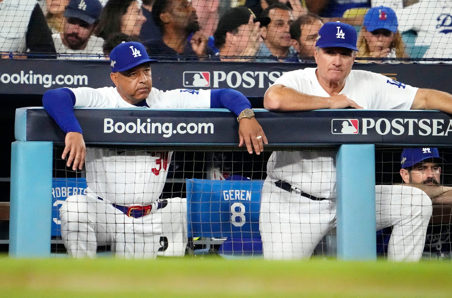 Los Angeles Dodgers' manager Dave Roberts adjusts field positions in the  second inning during the Dodgers home opener agains the Arizona  Diamondbacks at Dodger Stadium in Los Angeles on April 12, 2016.