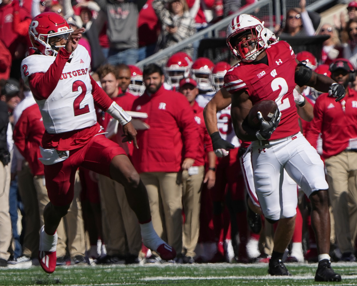 Oct 7, 2023; Madison, Wisconsin, USA; Wisconsin cornerback Ricardo Hallman (2) runs 95 yards for a touchdown after an interception during the second quarter of their game against Rutgers at Camp Randall Stadium. Mandatory Credit: Mark Hoffman-USA TODAY Sports