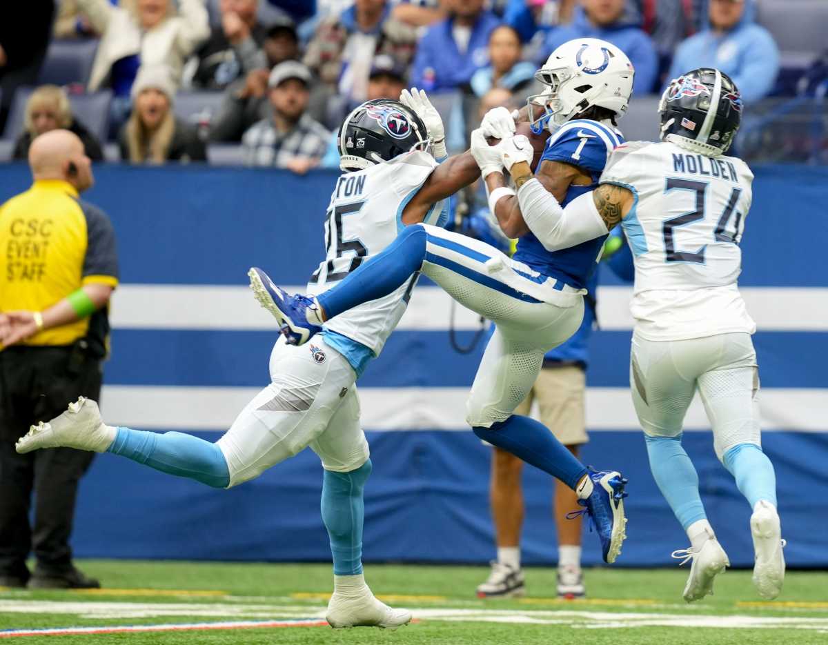 Indianapolis Colts wide receiver Josh Downs (1) makes a catch between Tennessee Titans cornerback Kristian Fulton (26) and Tennessee Titans cornerback Elijah Molden (24) on Sunday, Oct. 8, 2023, during a game against the Tennessee Titans at Lucas Oil Stadium in Indianapolis.