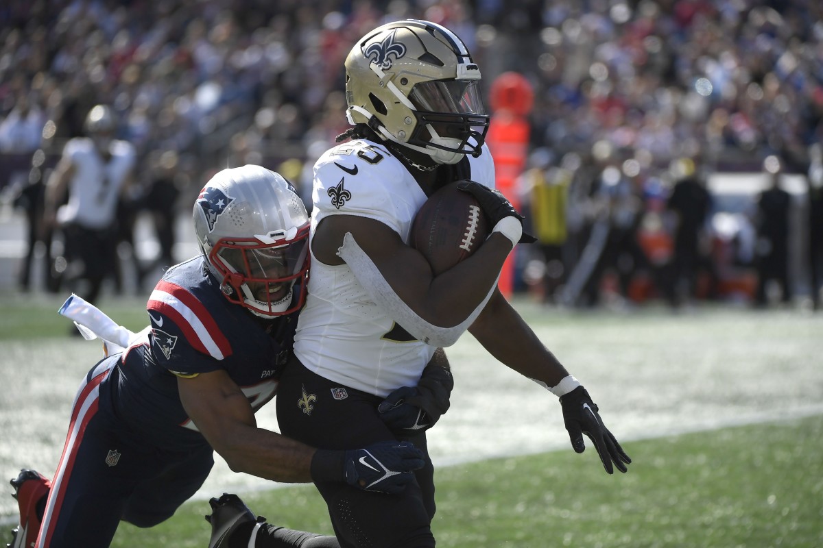 New England Patriots safety Adrian Phillips (21) tackles New Orleans Saints running back Kendre Miller (25) after a big gain. Mandatory Credit: Bob DeChiara-USA TODAY Sports