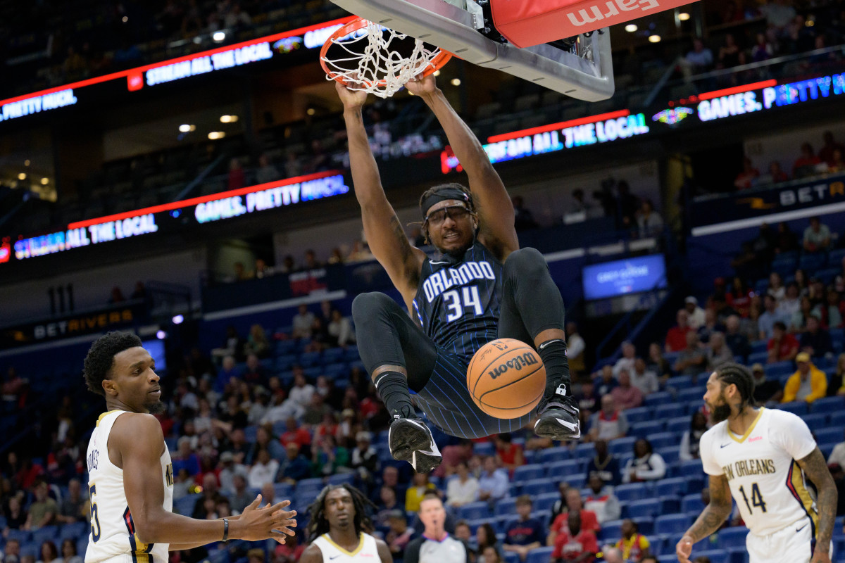 Wendell Carter Jr. (34) throwing down a dunk and hanging off of the rim. 