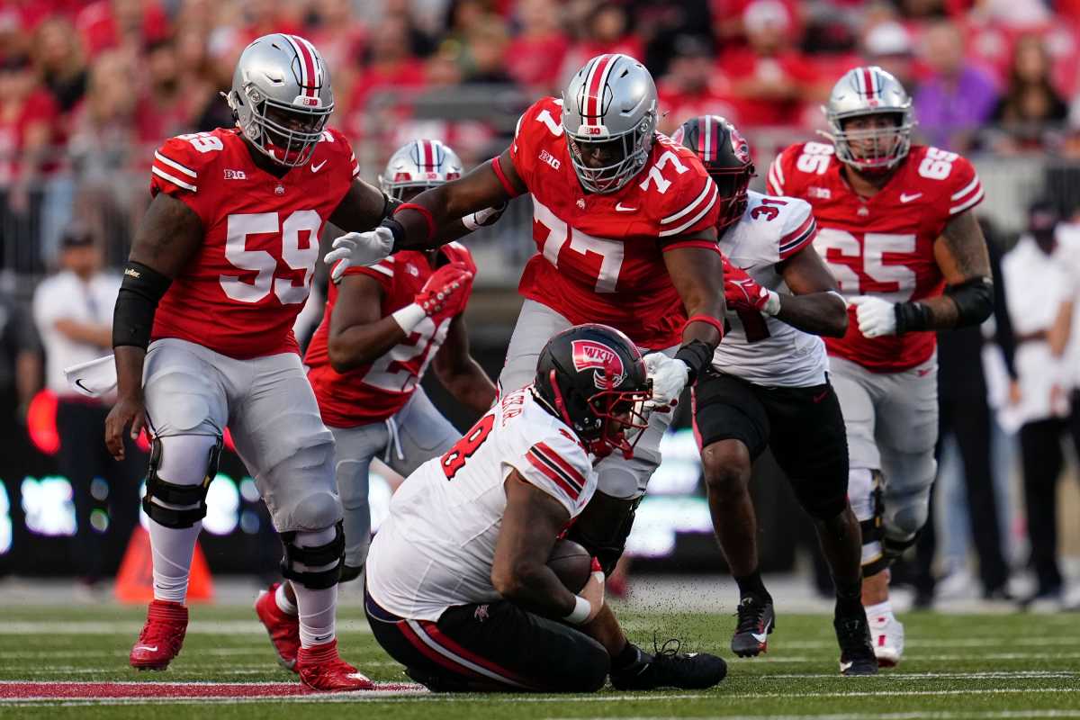 Ohio State Buckeyes offensive lineman Tegra Tshabola (77) goes to tackle Western Kentucky Hilltoppers defensive tackle Hosea Wheeler (98) during the NCAA football game at Ohio Stadium.