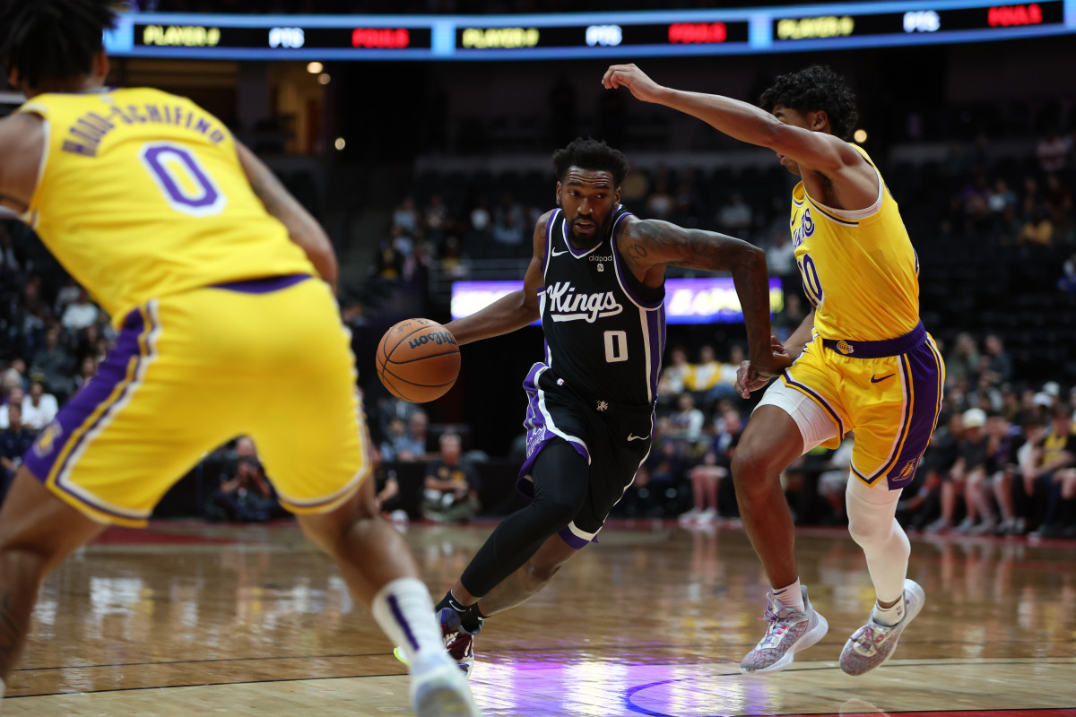 Oct 11, 2023; Anaheim, California, USA; Sacramento Kings guard Malik Monk (0) dribbles the ball against Los Angeles Lakers guard Max Christie (10) during the first half at Honda Center. Mandatory Credit: Kiyoshi Mio-USA TODAY Sports  