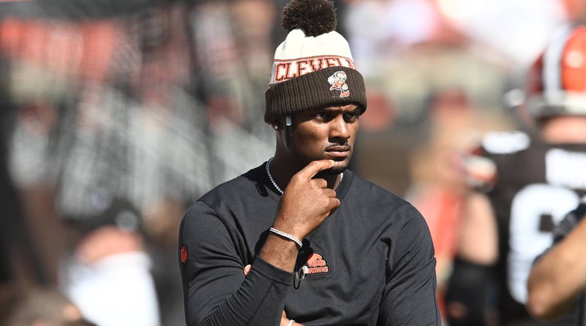 Browns quarterback Deshaun Watson looks on from the sidelines while inactive during a game.