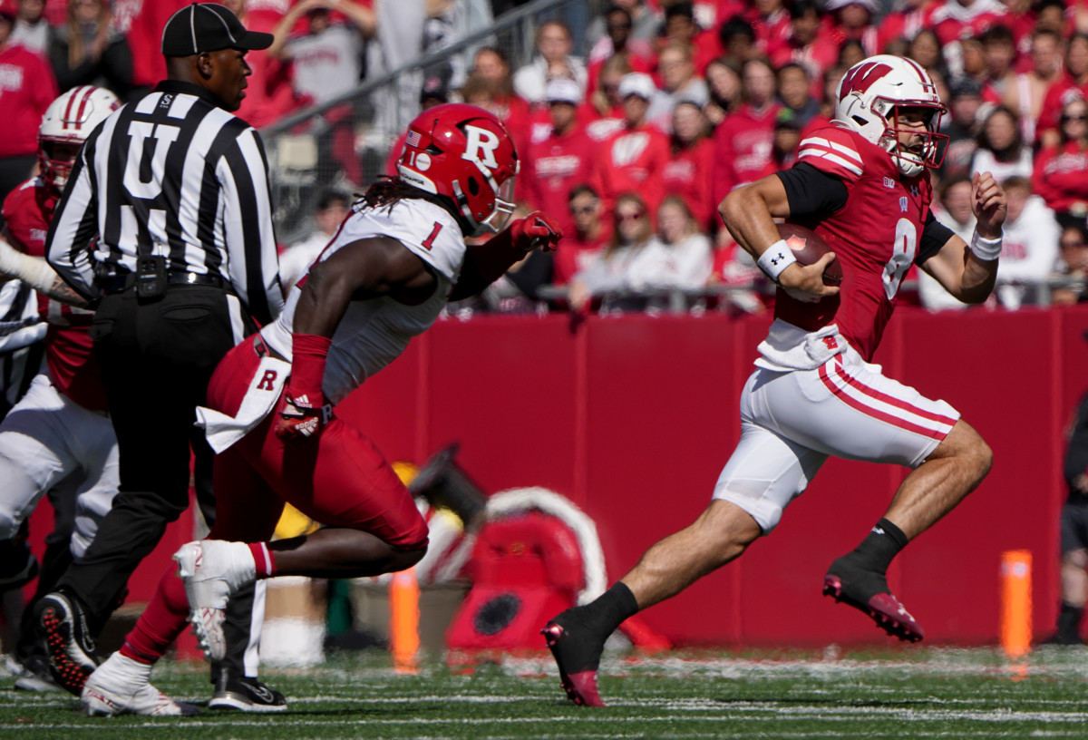 Oct 7, 2023; Madison, Wisconsin, USA; Wisconsin quarterback Tanner Mordecai (8) is pursued b Rutgers linebacker Mohamed Toure (1) while running the ball on a keeper during the third quarter at Camp Randall Stadium. Mandatory Credit: Mark Hoffman-USA TODAY Sports