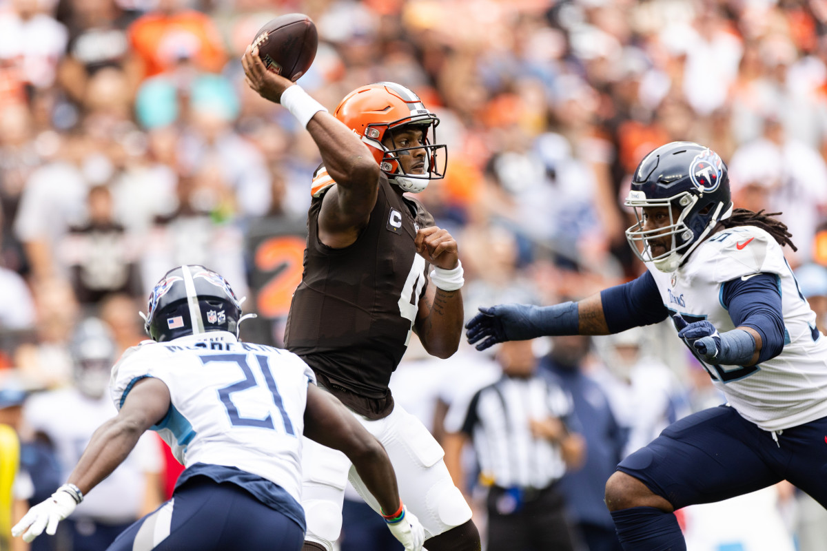 Sep 24, 2023; Cleveland, Ohio, USA; Cleveland Browns quarterback Deshaun Watson (4) throws the ball as Tennessee Titans cornerback Roger McCreary (21) and defensive end Denico Autry (96) pressure him during the first quarter at Cleveland Browns Stadium. 
