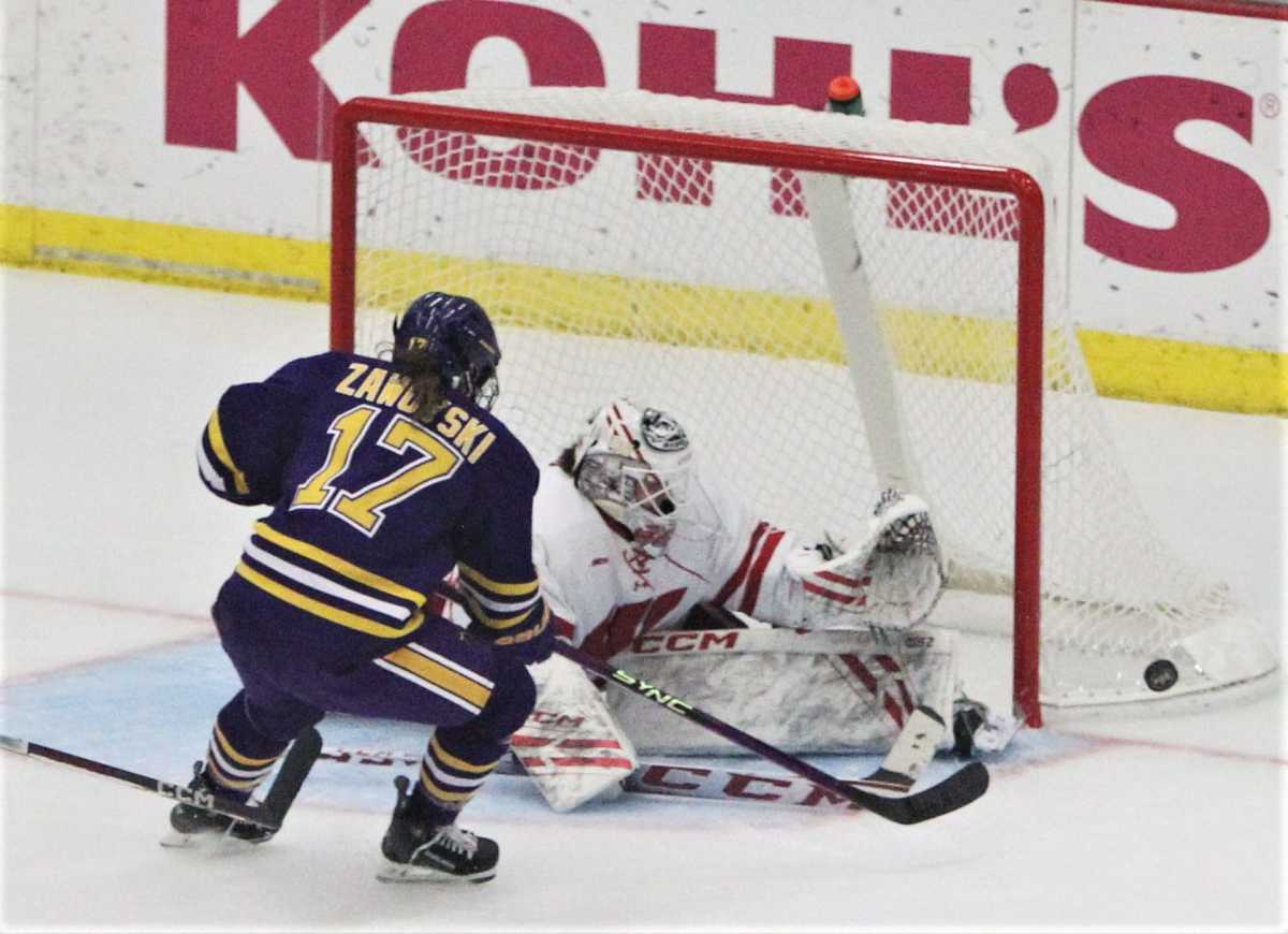 Wisconsin goaltender Jane Gervais stops a shot by Minnesota State's Lauren Zawoyski (17) during the second period at LaBahn Arena in Madison, Wisconsin on Thursday Oct. 12, 2023.