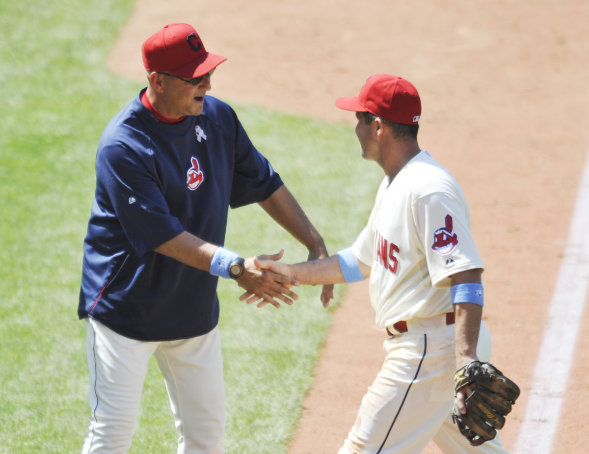 Jun 16, 2013; Cleveland, OH, USA; Cleveland Indians manager Terry Francona (left) and third baseman John McDonald (7) celebrate a 2-0 win over the Washington Nationals at Progressive Field.