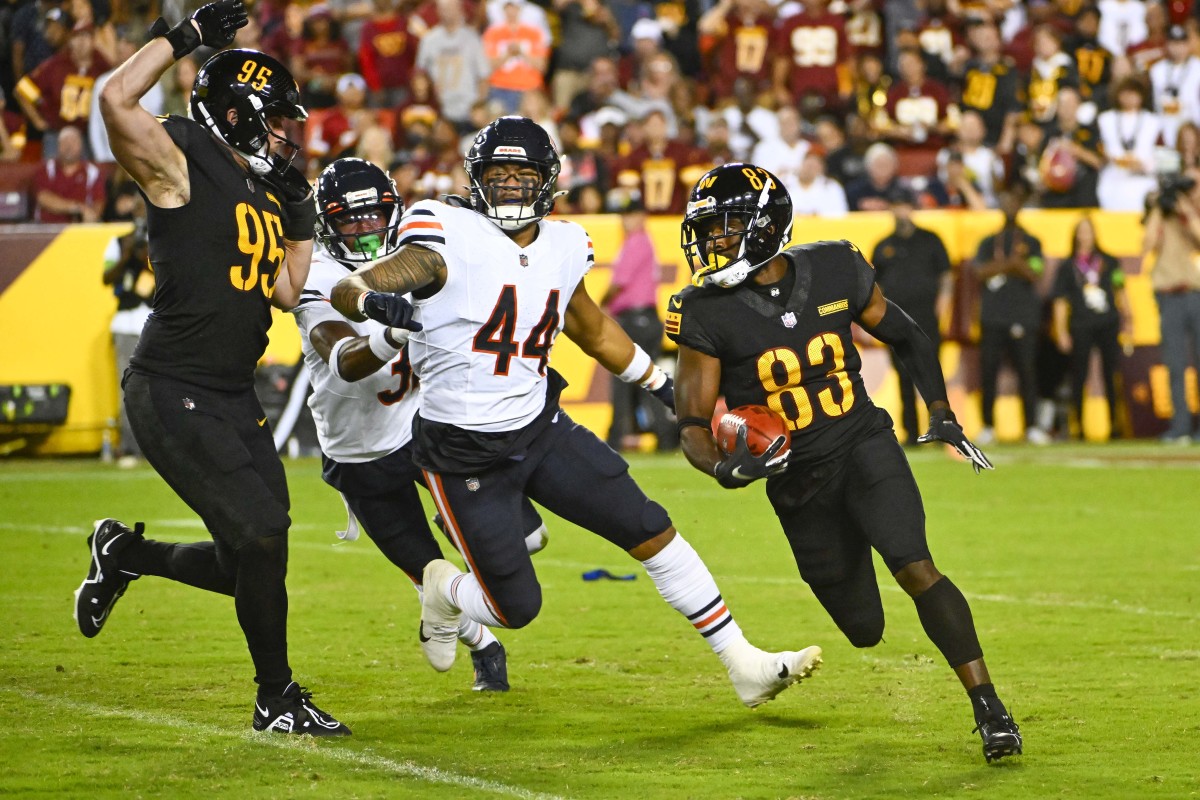 Washington Commanders wide receiver Jamison Crowder (83) carries the ball against the Chicago Bears during the second half at FedExField.