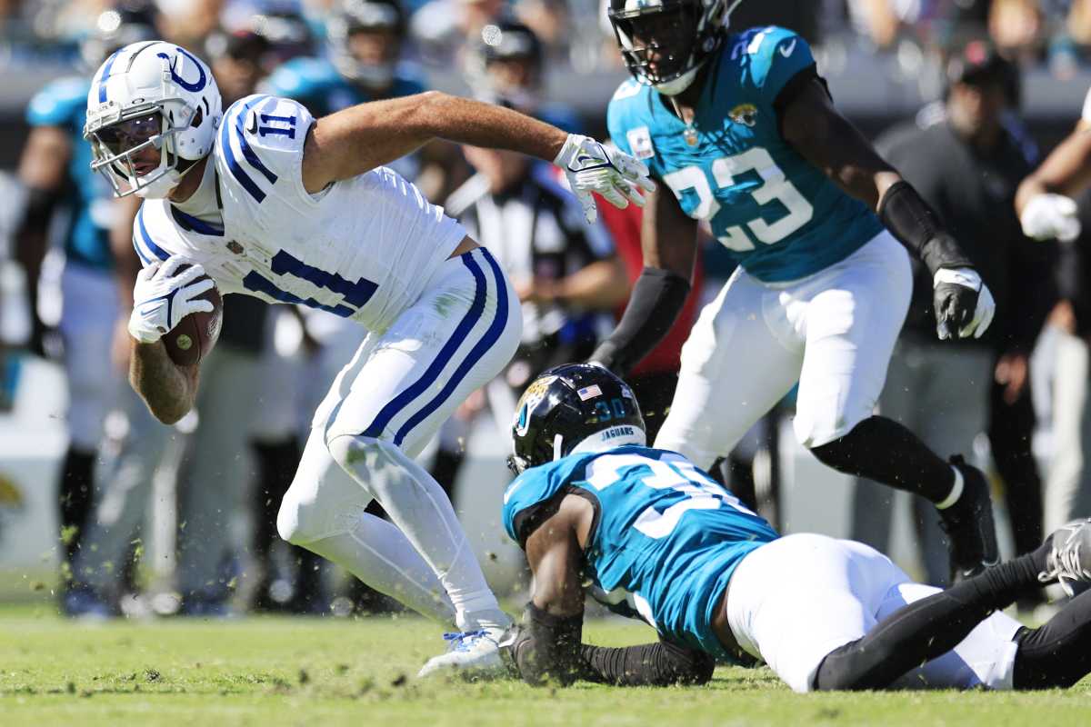 Indianapolis Colts wide receiver Michael Pittman Jr. (11) escapes Jacksonville Jaguars cornerback Montaric Brown (30) during the fourth quarter of an NFL football matchup Sunday, Oct. 15, 2023 at EverBank Stadium in Jacksonville, Fla. The Jacksonville Jaguars defeated the Indianapolis Colts 37-20. [Corey Perrine/Florida Times-Union]