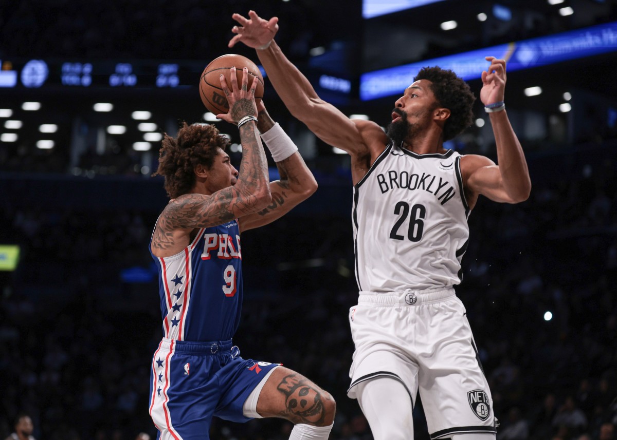 76ers' Kelly Oubre attempting a shot over Nets' Spencer Dinwiddie.