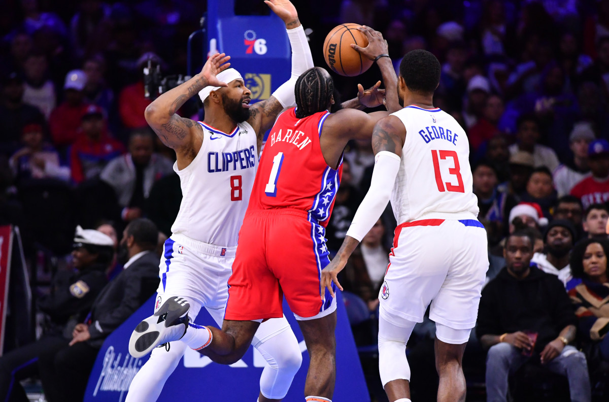 James Harden goes up for a layup while Paul George and Marcus Morris Sr. try to defend him