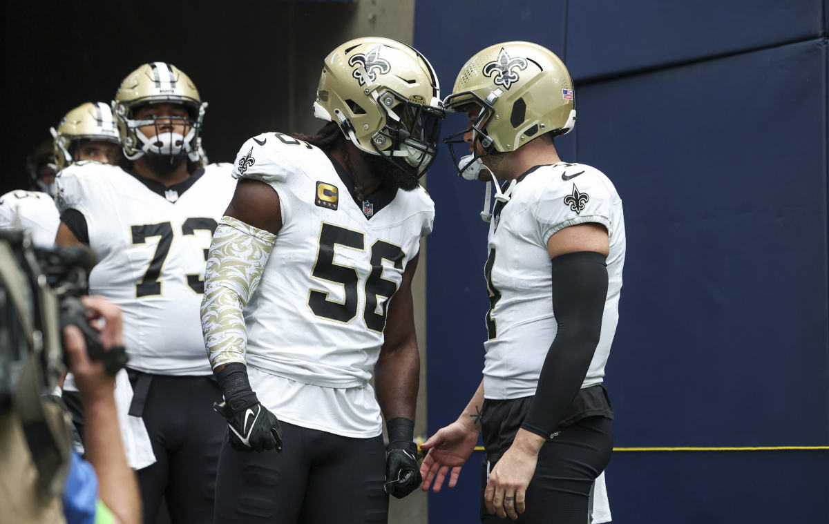 New Orleans Saints linebacker Demario Davis (56) and quarterback Derek Carr (4) prepare to walk onto the field before the game against the Houston Texans