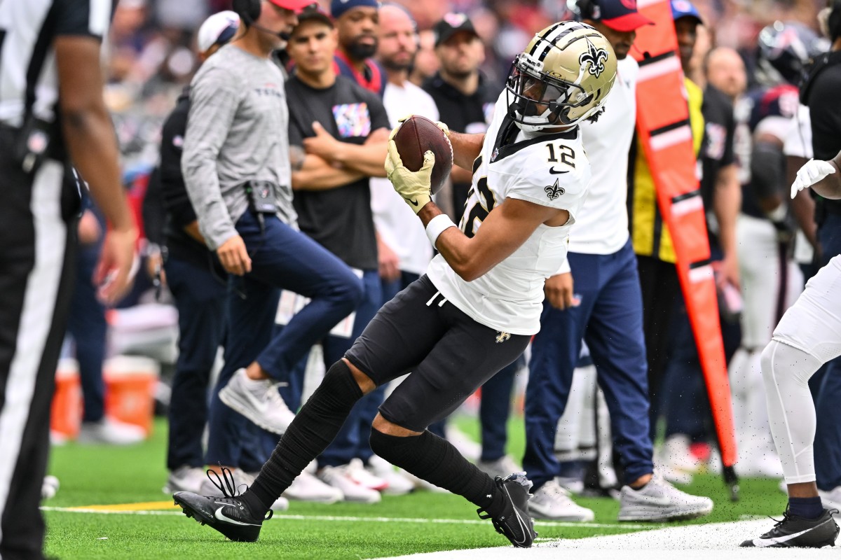 New Orleans Saints wide receiver Chris Olave (12) runs out of bounds 