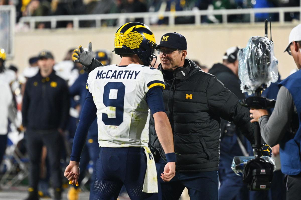 J.J. McCarthy and Jim Harbaugh celebrating after a score