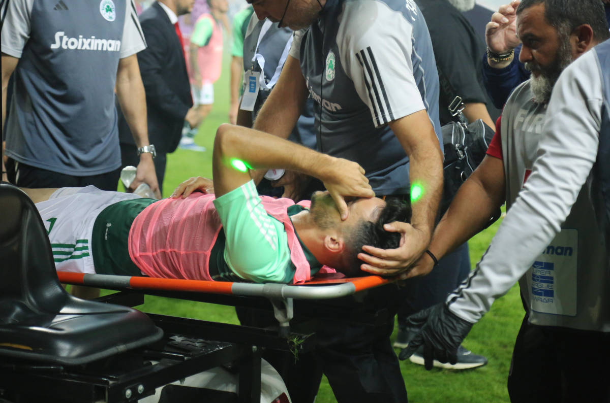 Panathinaikos defender Juankar pictured leaving the field on a stretcher after being hit by a firework during an away game at Olympiakos in October 2023