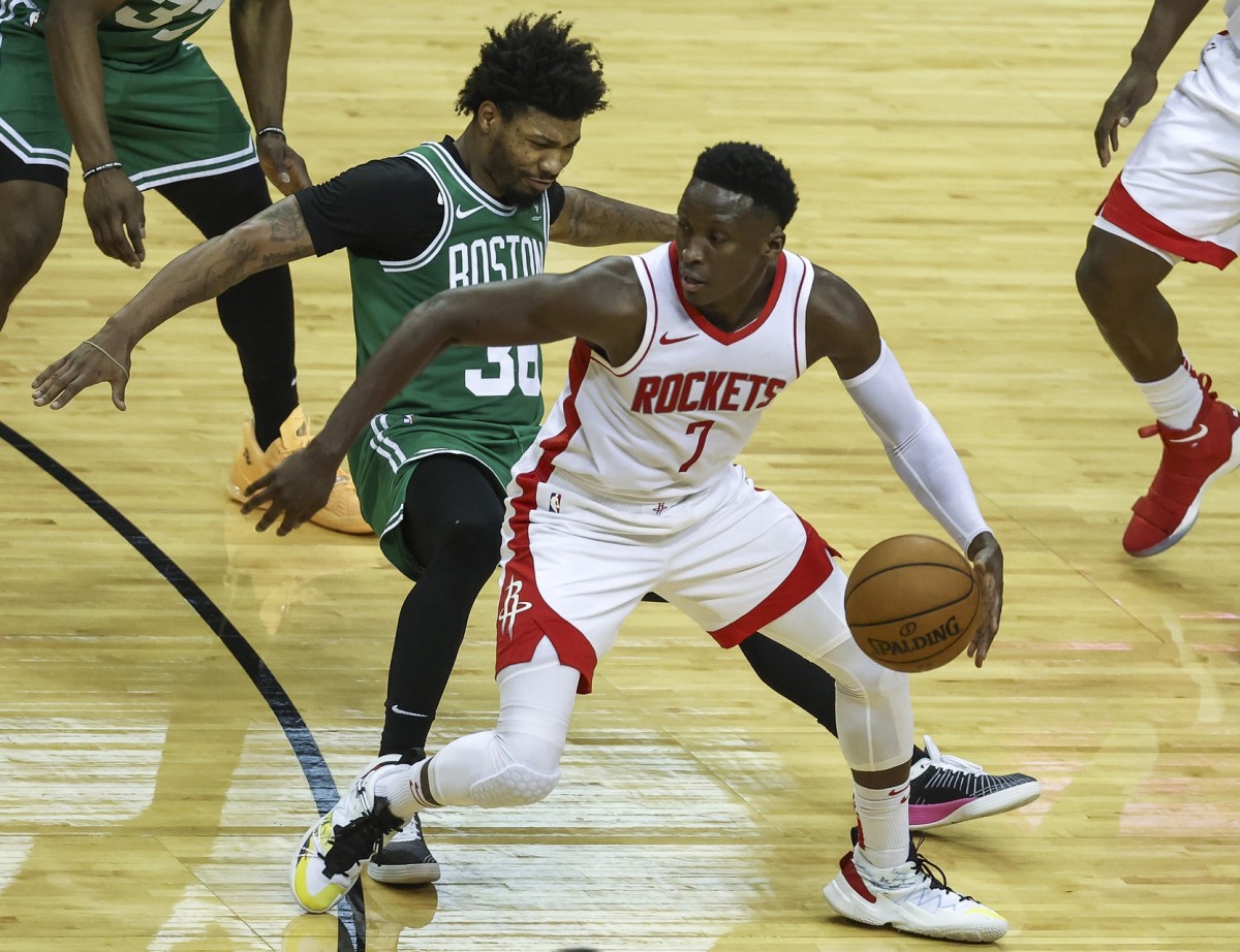 Houston Rockets guard Victor Oladipo (7) dribbles the ball as Boston Celtics guard Marcus Smart (36) defends during the second quarter at Toyota Center.