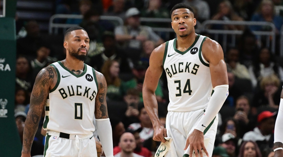 Giannis Antetokounmpo and Damian Lillard on the court.