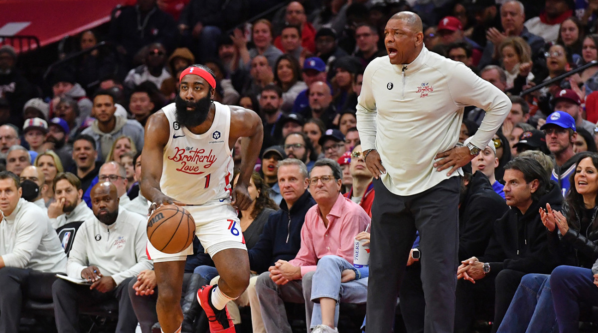 76ers guard James Harden (1) pushes the ball up court past coach Doc Rivers against the Celtics at Wells Fargo Center.