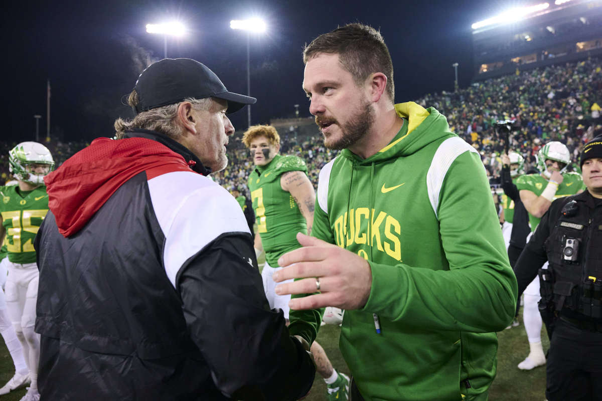 Nov 19, 2022; Eugene, Oregon, USA; Utah Utes head coach Kyle Whittingham congratulates Oregon Ducks head coach Dan Lanning after a game at Autzen Stadium. The Ducks won the game 20-17. Mandatory Credit: Troy Wayrynen-USA TODAY Sports