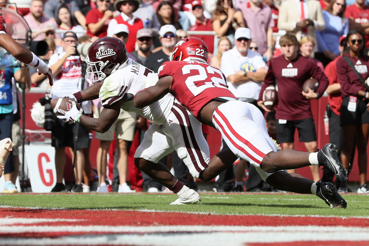 Oct 21, 2023; Fayetteville, Arkansas, USA; Mississippi State Bulldogs running back Jo Quavious Marks (7) scores a touchdown against the Arkansas Razorbacks in the second quarter at Donald W. Reynolds Razorback Stadium. Mandatory Credit: Nelson Chenault-USA TODAY Sports